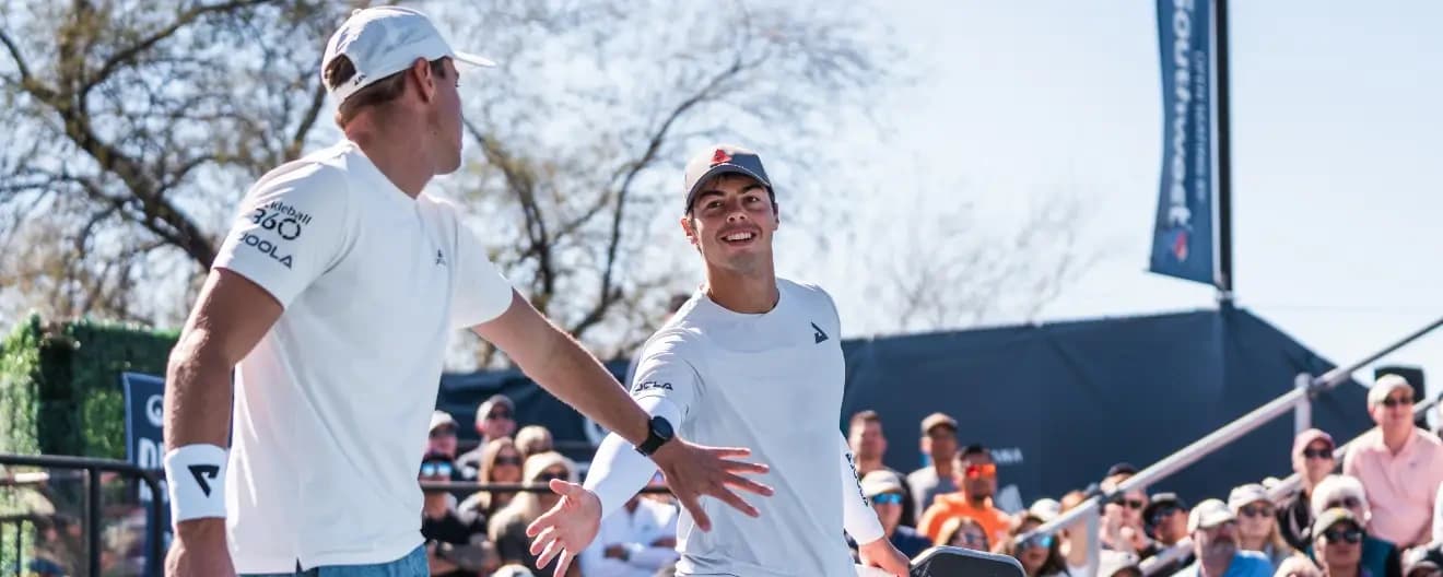 Ben and Collin Johns high-five each other.