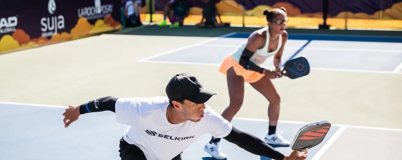 Pablo Tellez and Jessie Irvine playing pickleball.