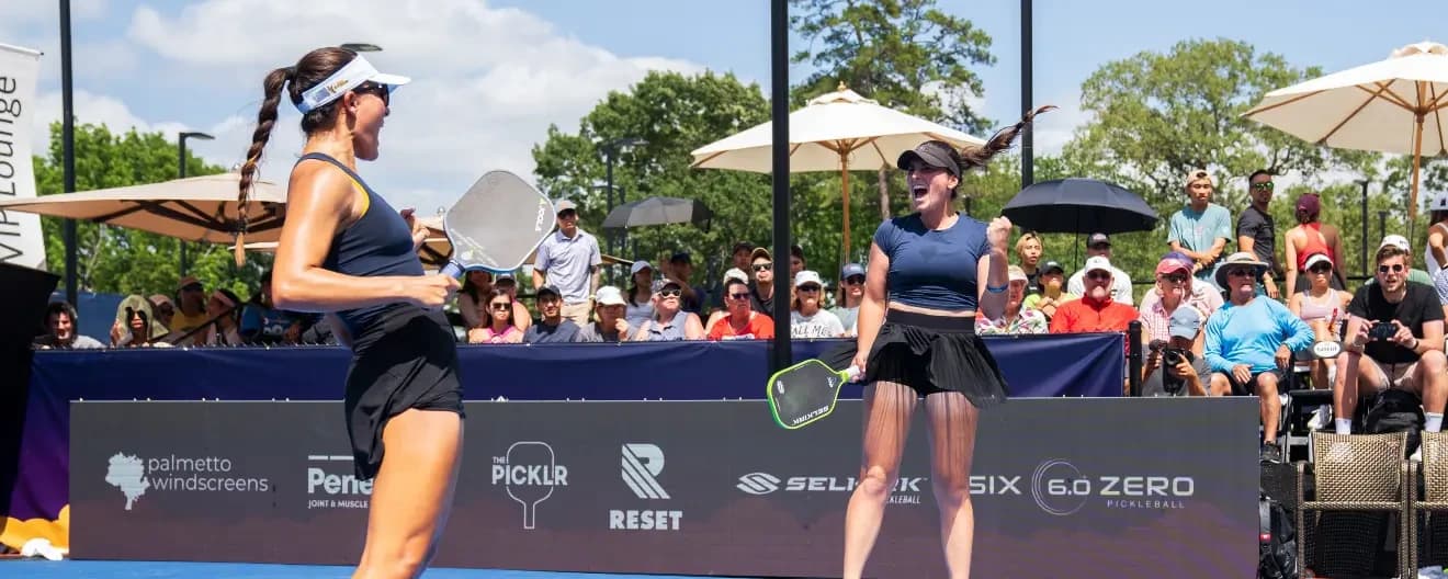 Anna Bright and Rachel Rohrabacher celebrate a pickleball victory.