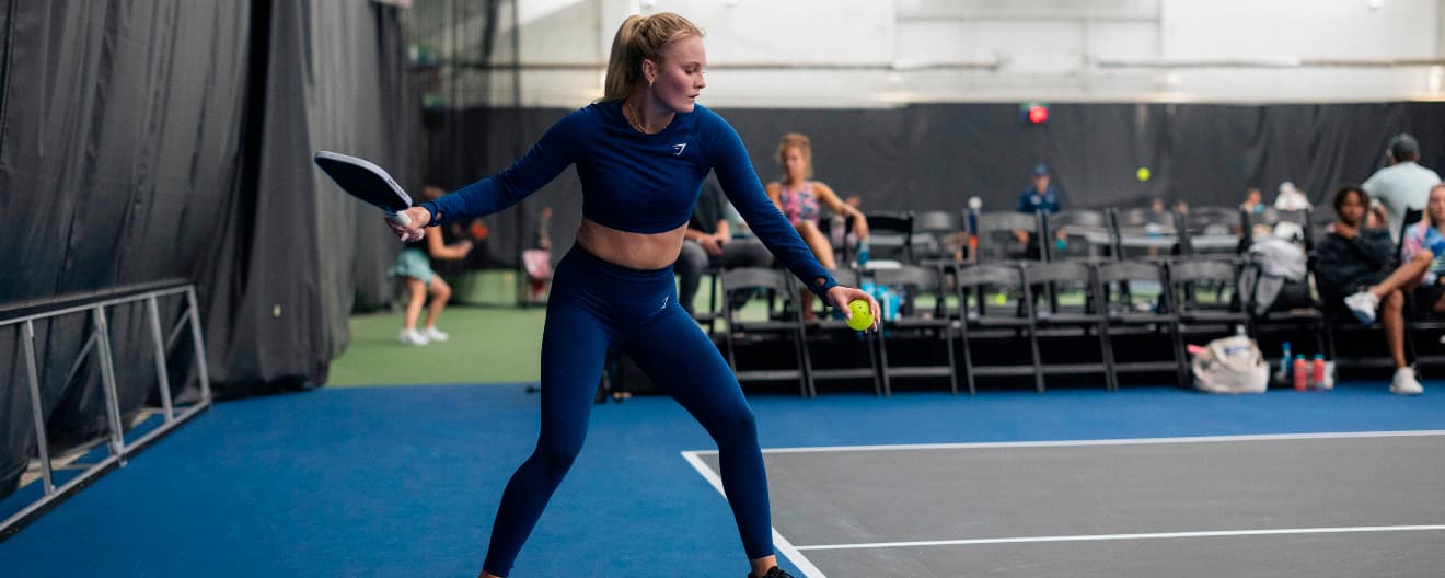 Layne Sleeth hits a pickleball serve.