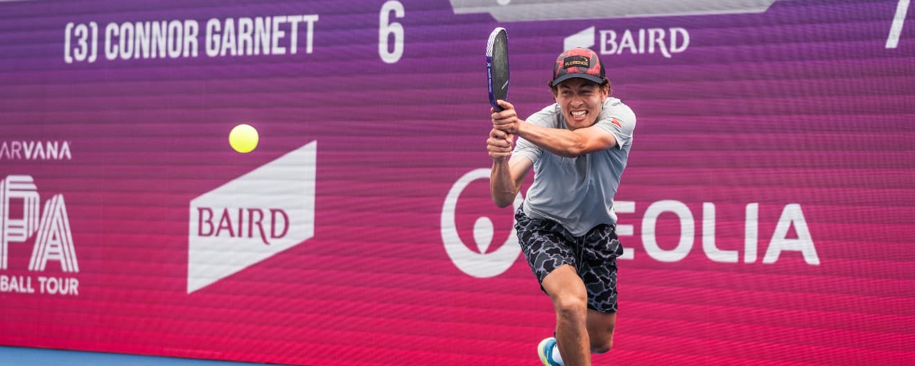 Connor Garnett hits a pickleball backhand.