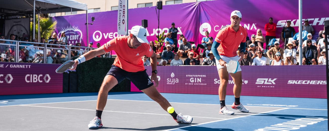 Collin Johns hits a forehand dink during a pickleball point.