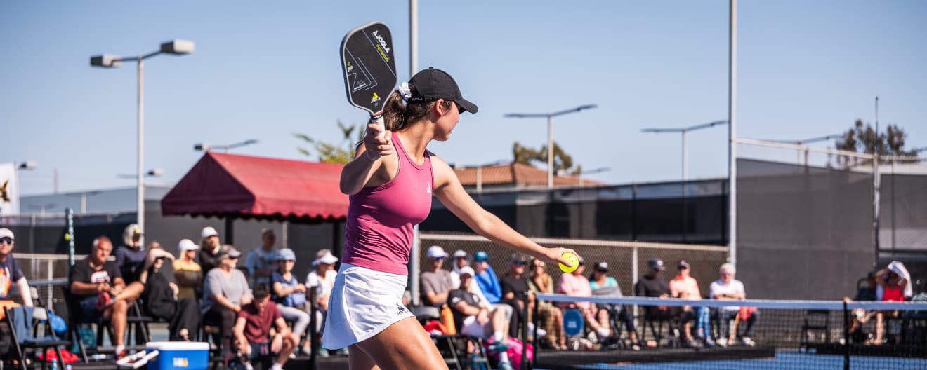 Vivian Glozman hits a pickleball serve.
