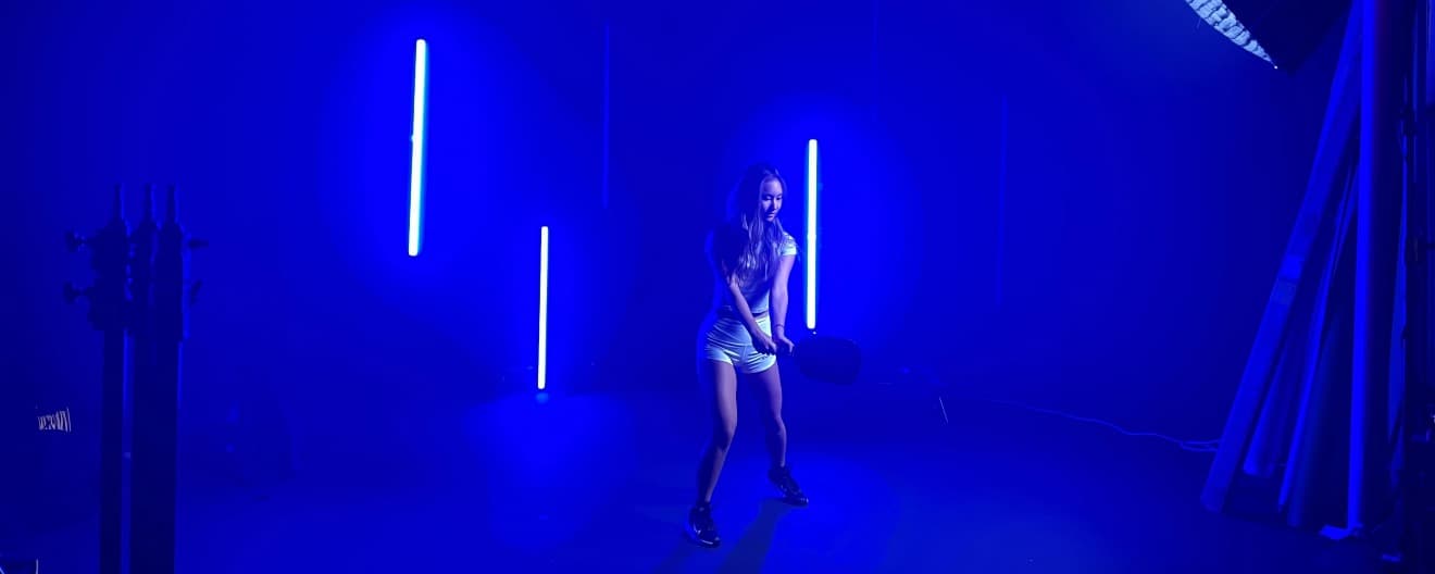 Alix Troung at a studio with blue lighting illuminating her silhouette.