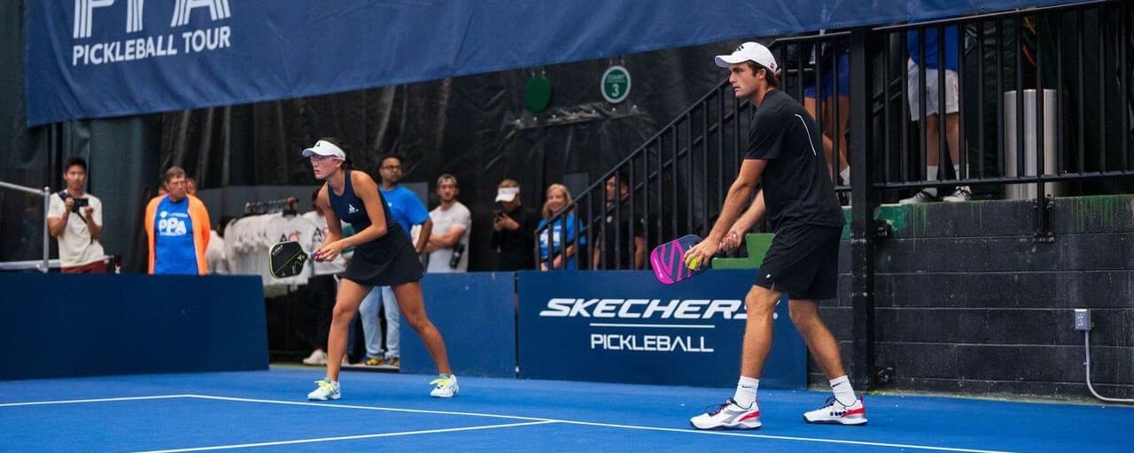 James Ignatowich and Anna Bright getting ready to serve