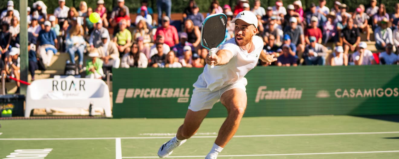 Federico Staksrud hitting a backhand volley.