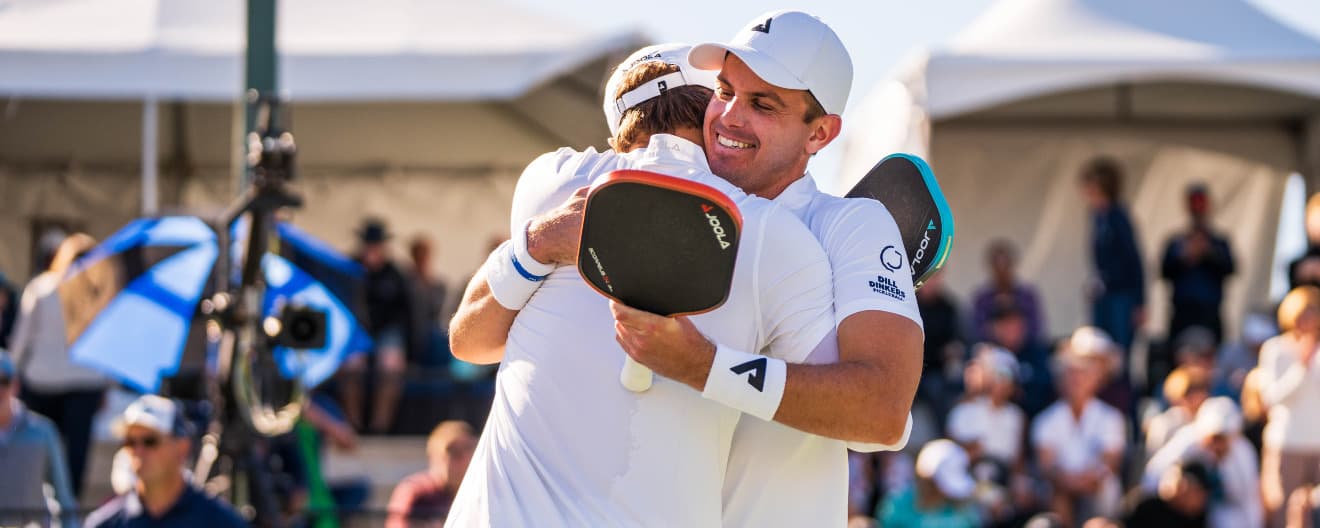 Collin Johns and Ben Johns embrace after earning a title in their final tournament together.
