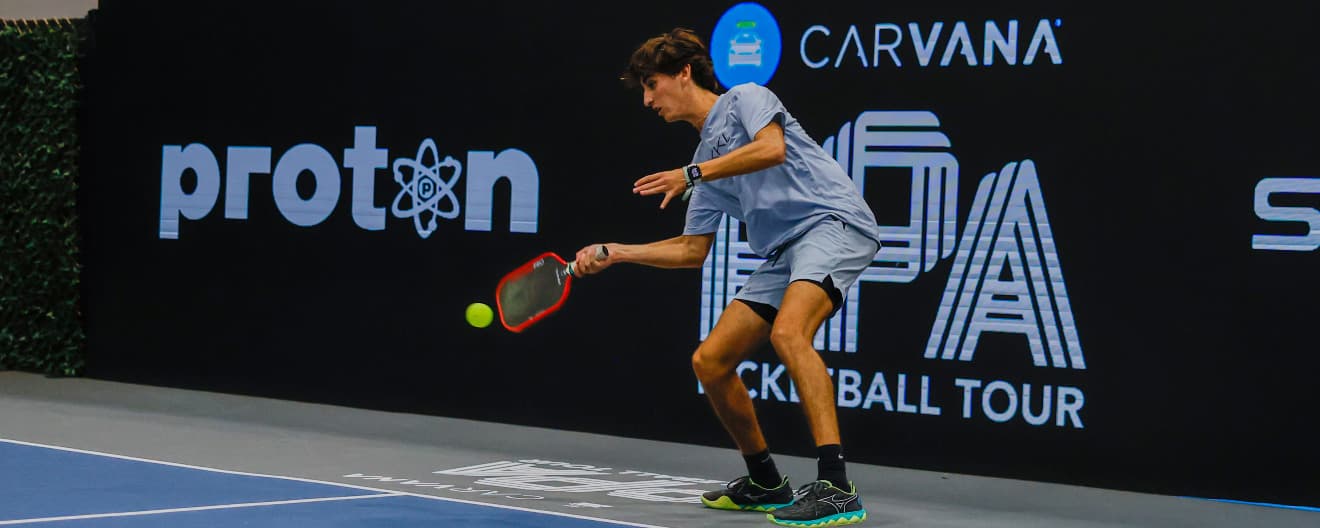Gabe Tardio hitting a pickleball forehand.