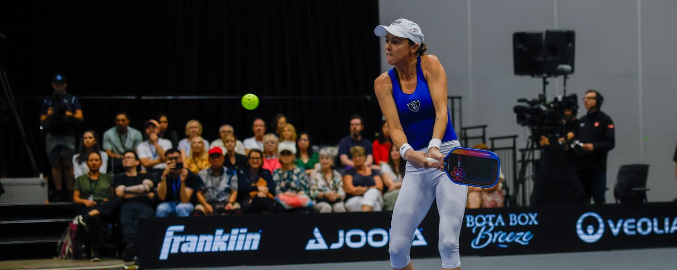 Kaitlyn Christian hits a backhand volley.