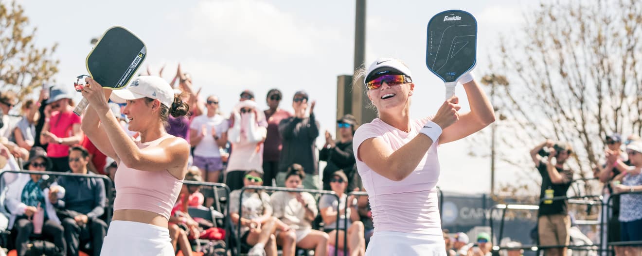 Anna Bright and Anna Leigh Waters celebrating their women's doubles title.