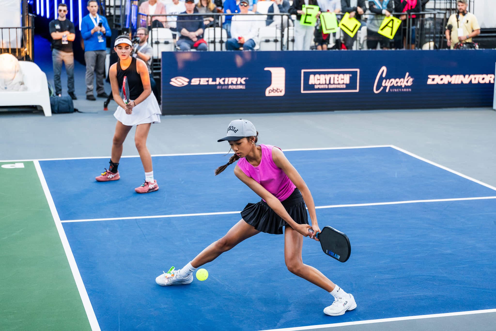Junior PPA Tour players competing in a doubles match on stadium court.