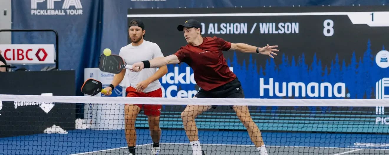 Christian Alshon hits a forehand volley in pickleball.