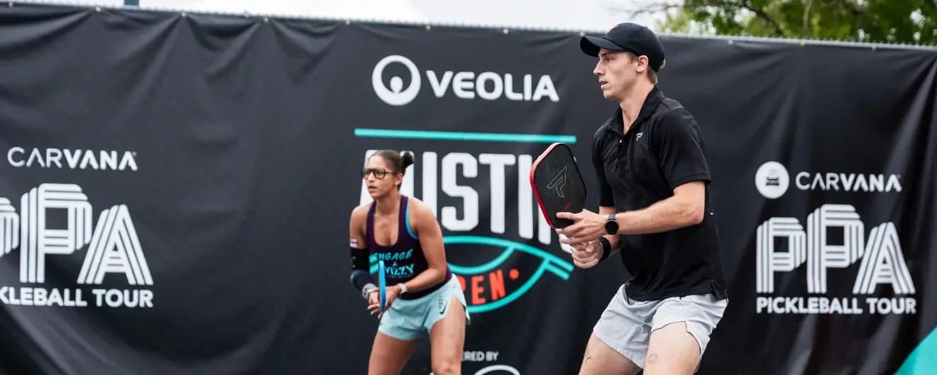 Jessie Irvine and Christian Alshon playing pickleball mixed doubles.