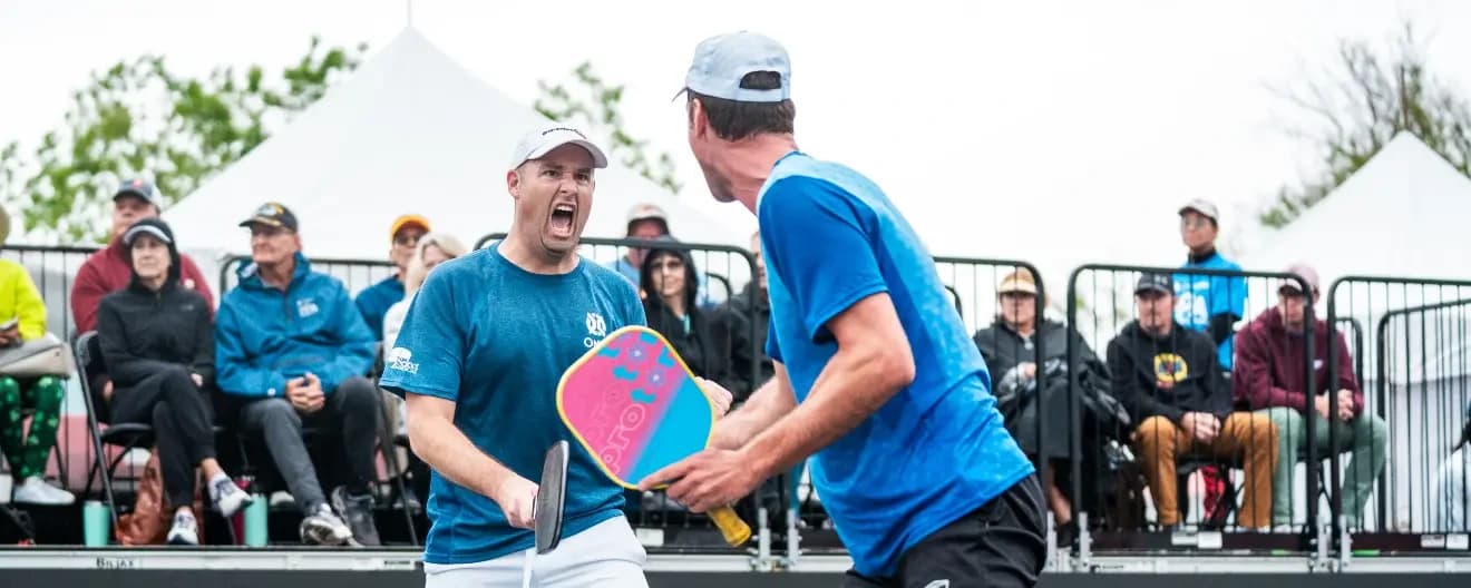 Matt Wright and Andrei Daescu celebrate a victory in pickleball.