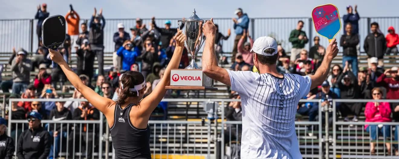 Anna Bright and Andrei Daescu celebrate a pickleball win.