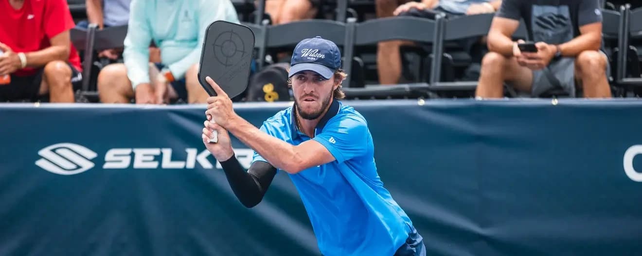 Hunter Johnson hits a pickleball backhand.