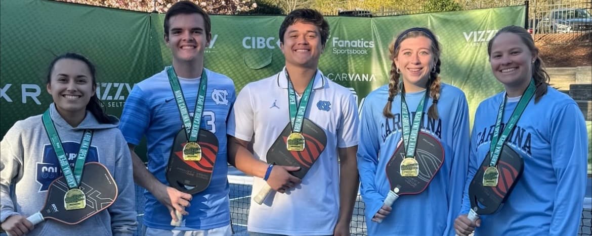 Club Pickleball at UNC team smiling with their gold medals.