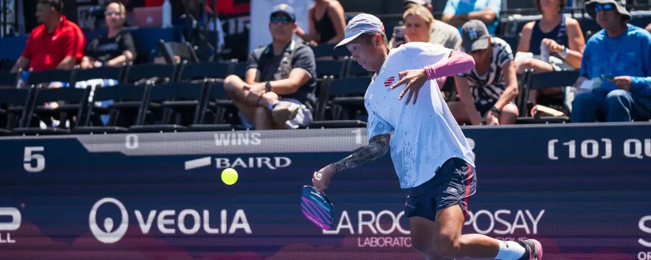 Quang Dong hits a pickleball forehand.