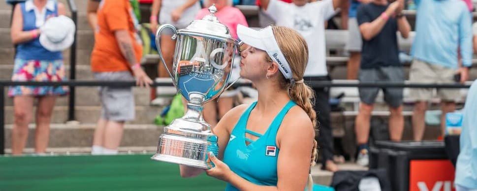 Anna Leigh Waters kissing a trophy