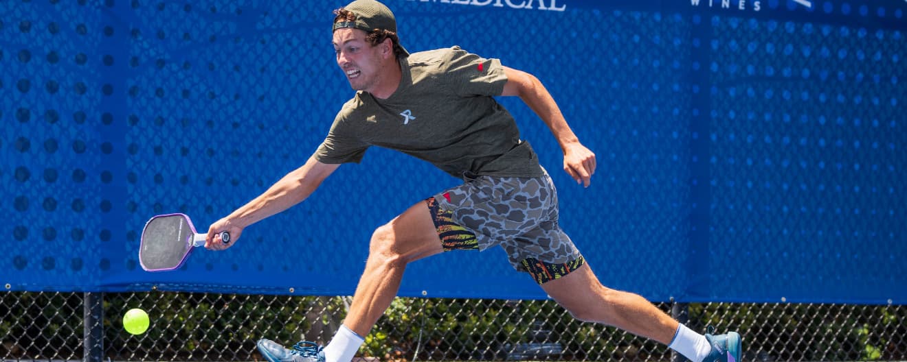 Connor Garnett hitting a forehand on the run.