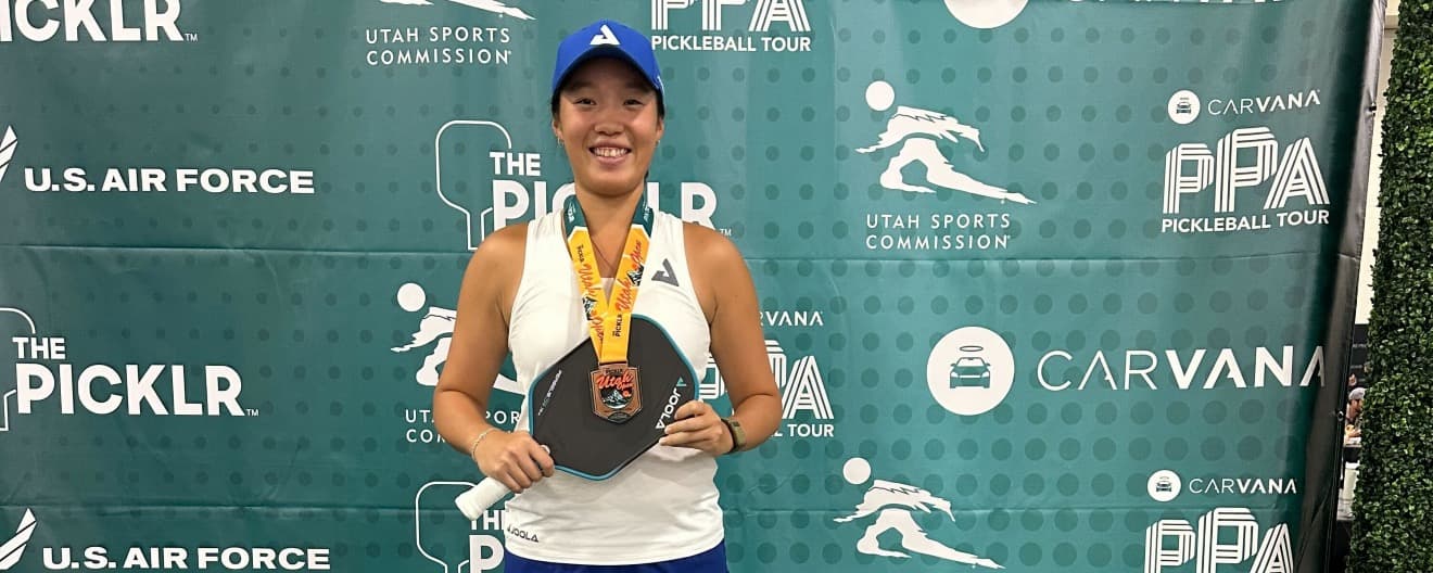 Zoey Wang celebrating a bronze medal victory in Utah.