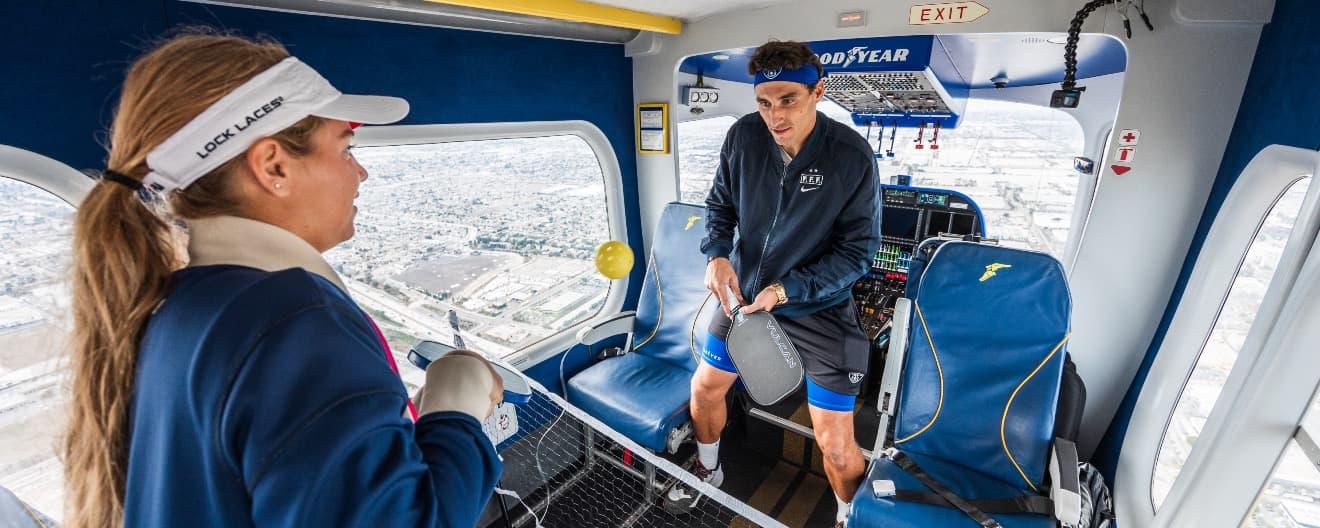 Anna Leigh Waters and Jay Devilliers playing pickleball on the Goodyear Blimp.