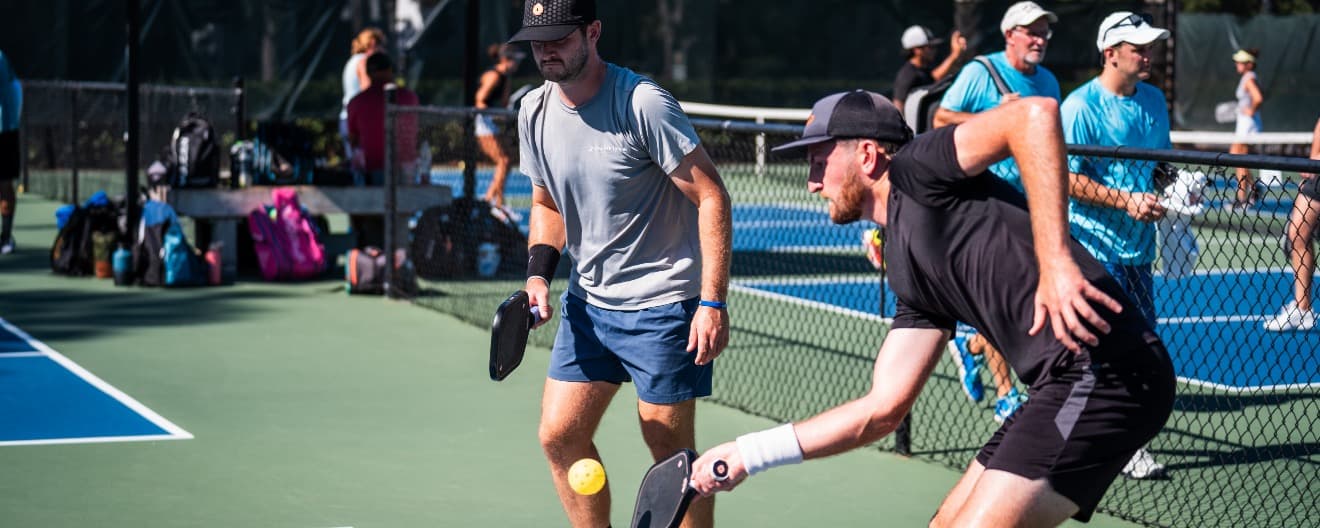 Players competing on a pickleball court.