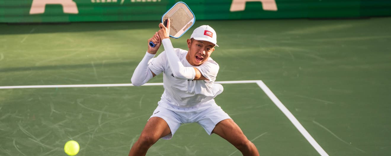 Quang Duong hits a backhand.