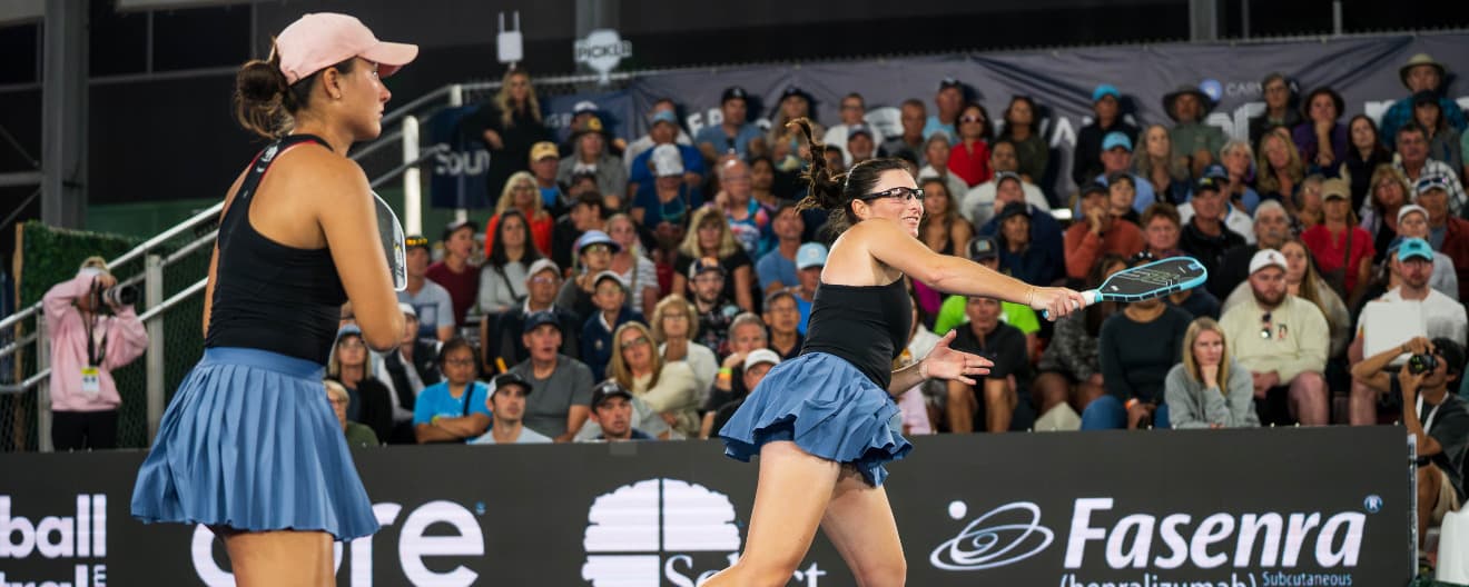 Rachel Rohrabacher and Anna Bright playing women's doubles.