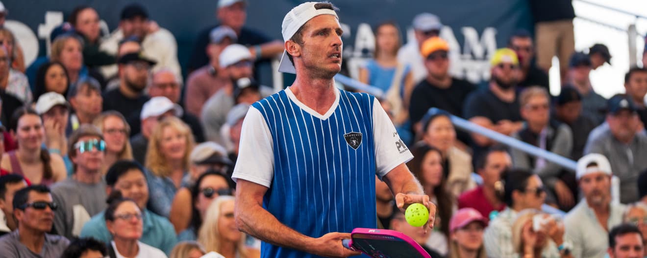Andrei Daescu prepares to hit a picklball serve.