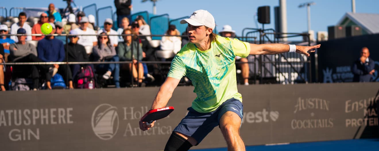 Christian Alshon hits a backhand volley in men's singles.