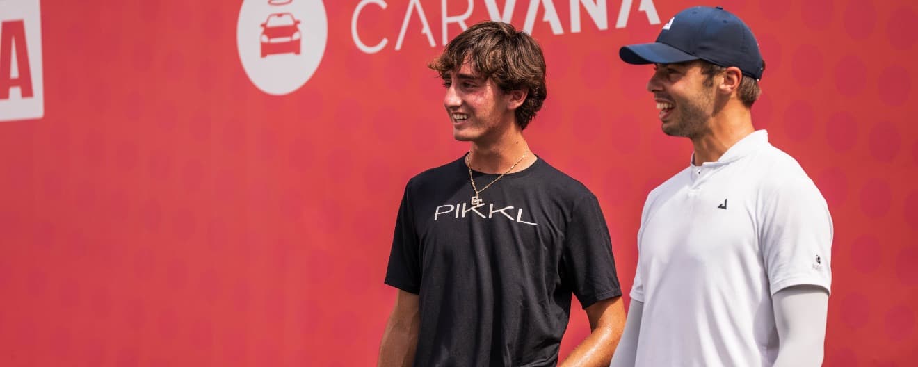 Gabe Tardio and Ben Johns smiling on the court.