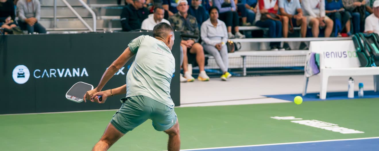 Gabe Joseph hitting a pickleball backhand.