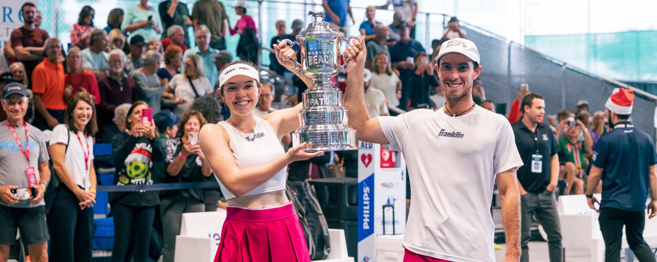 Jorja Johnson and JW Johnson celebrating with the mixed doubles trophy.