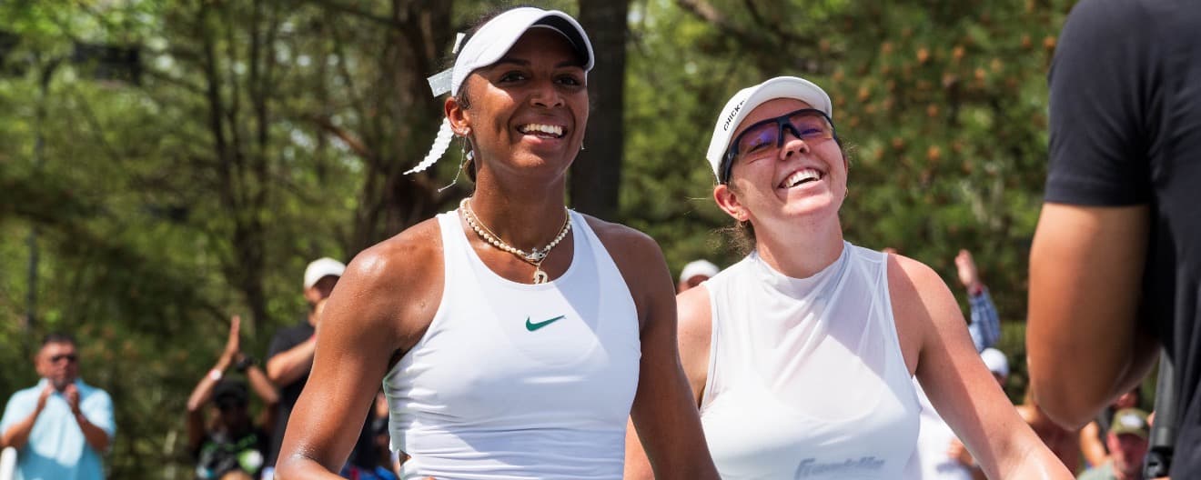 Tyra Black and Jorja Johnson smiling on the pickleball court.