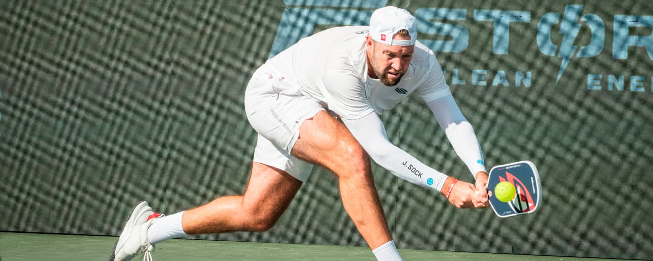 Jack Sock hitting a pickleball backhand.