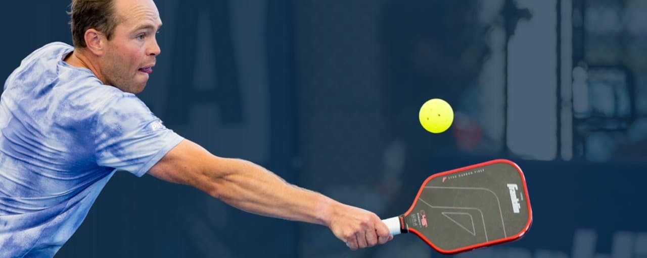 A player hitting a return on their backhand.